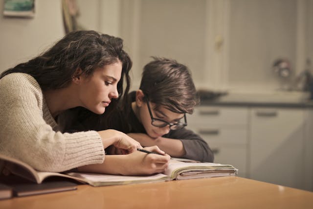 parent working at home with child doing homework